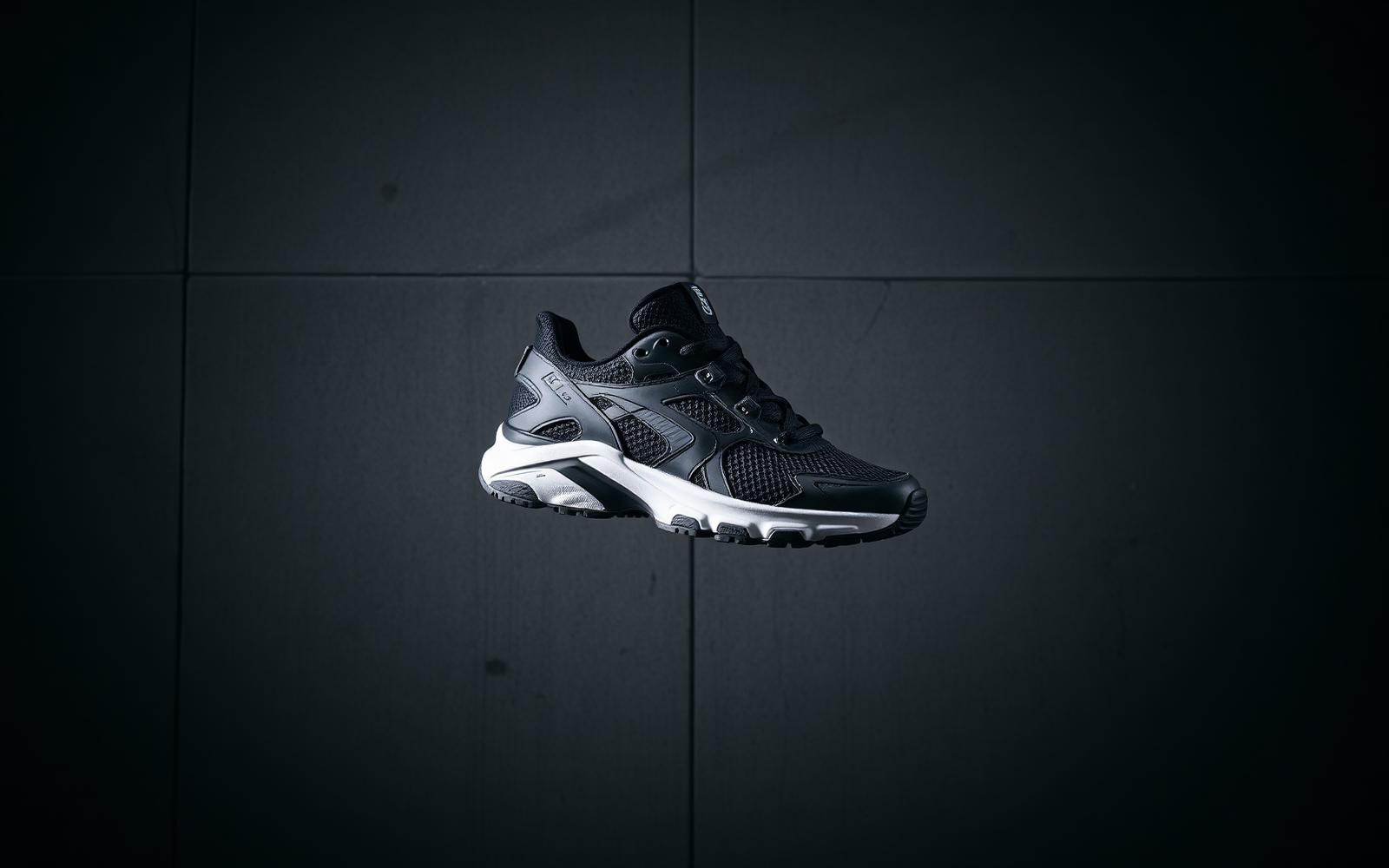 Technical running sneaker on a dark concrete backdrop